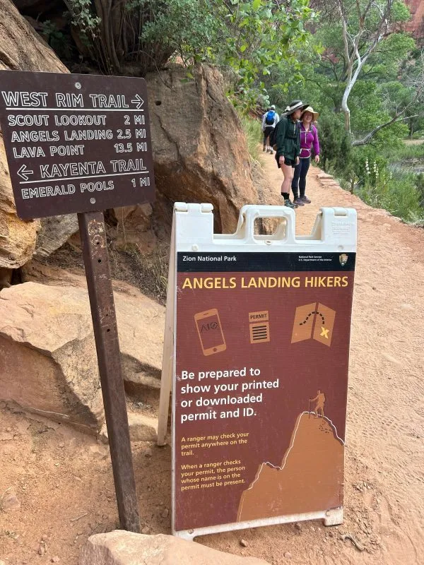 A sign warning Angels Landing hikers that they must show permit and ID.