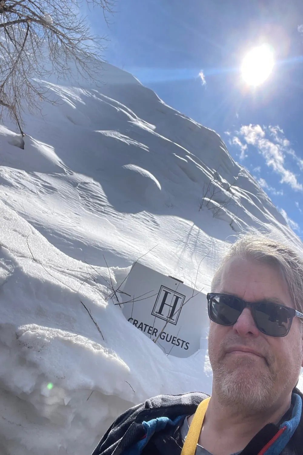 man in front of a sign reading "H Crater Guests"