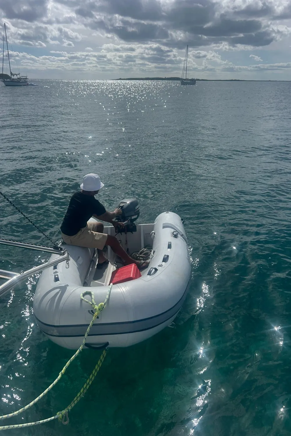 a man piloting a dinghy