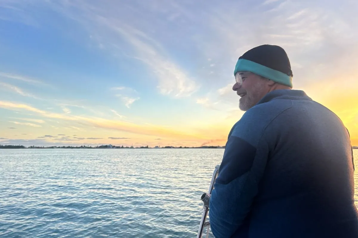 smiling man aboard a yacht