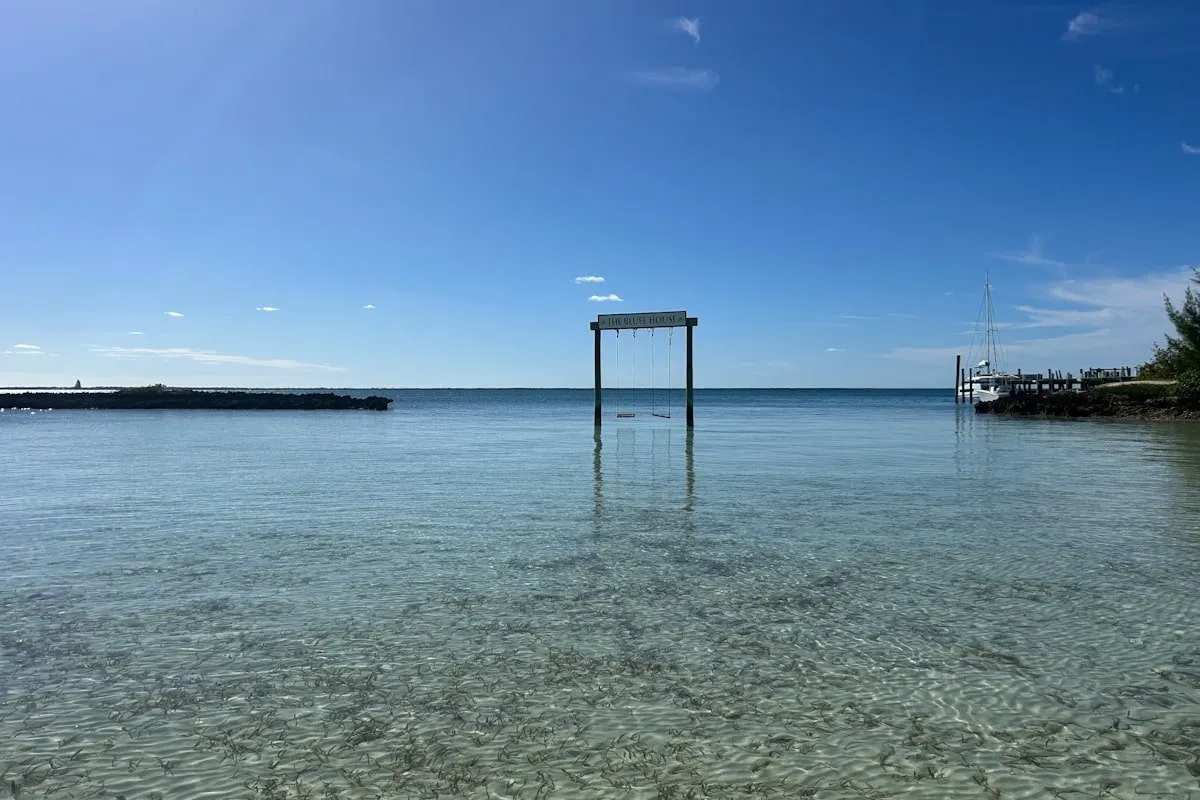 wooden swings over clear water in the Bahamas